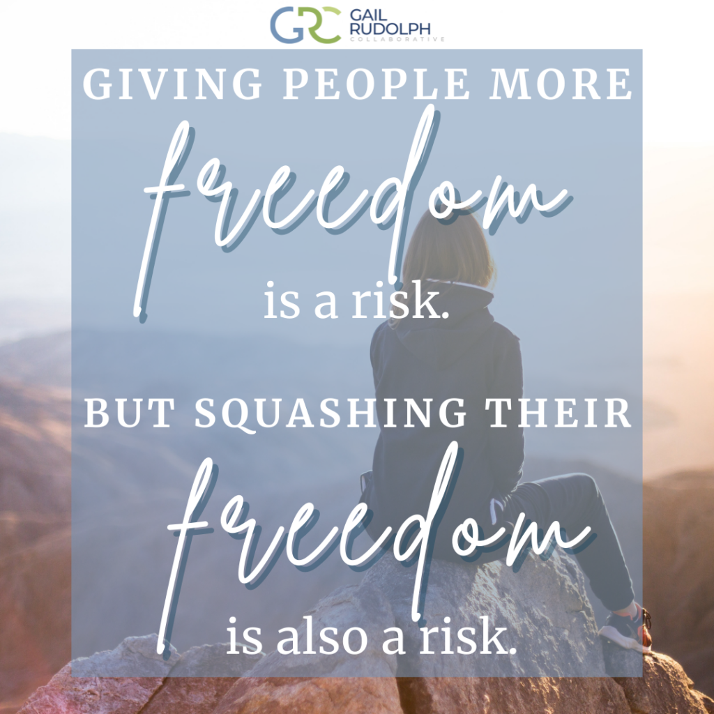 Woman sitting on a rock looking at hills. Quote: Giving people more freedom is a risk. But squashing their freedom is also a risk. 